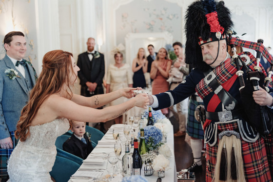 Bride shares a quaich with piper at Dean Banks at The Pompadour